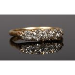 An 18 carat gold five stone diamond ring with diamond point spacers. Size P.