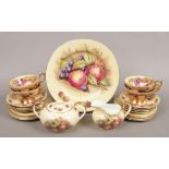 An Aynsley bone china part tea service, transfer printed with fruit on a blush ground, including