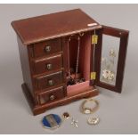 A wooden jewellery cabinet and contents of costume jewellery to include Sekonda wristwatch, Bourjois