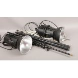 A pair of Courtenay solar flash 1000s photographic studio lights with reflectors and tripods.