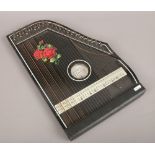 A boxed German guitar zither with rose decoration.