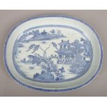 A 19th century Chinese export blue and white dish decorated with a river landscape.