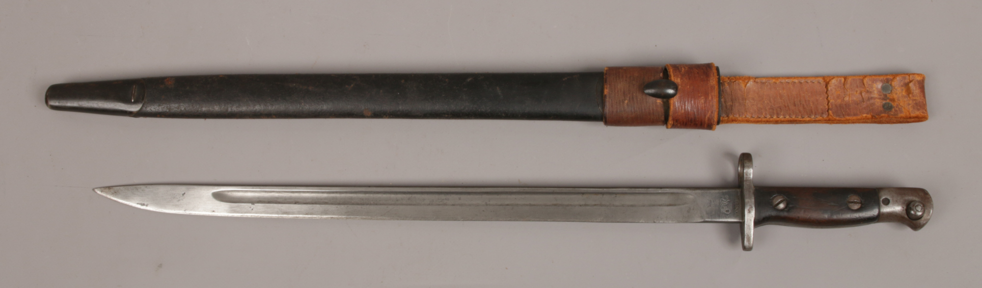 A 1907 World War One British bayonet in leather scabbard blade stamped Sanders.