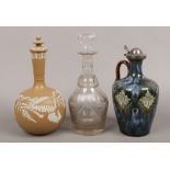 A 19th century Lambeth Scotch decanter along with a Victorian glass decanter and another pottery