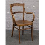 A Bentwood arm chair with designed seat.