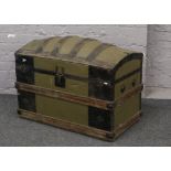 A late 19th / early 20th century metal and wood bound dome top trunk with decoupage decoration to