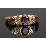 An 18ct gold ruby and diamond ring on scrolling shank. Size N.