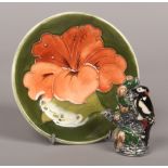 A Moorcroft dish in the hibiscus pattern diameter 12cm along with a Moorcroft model of a