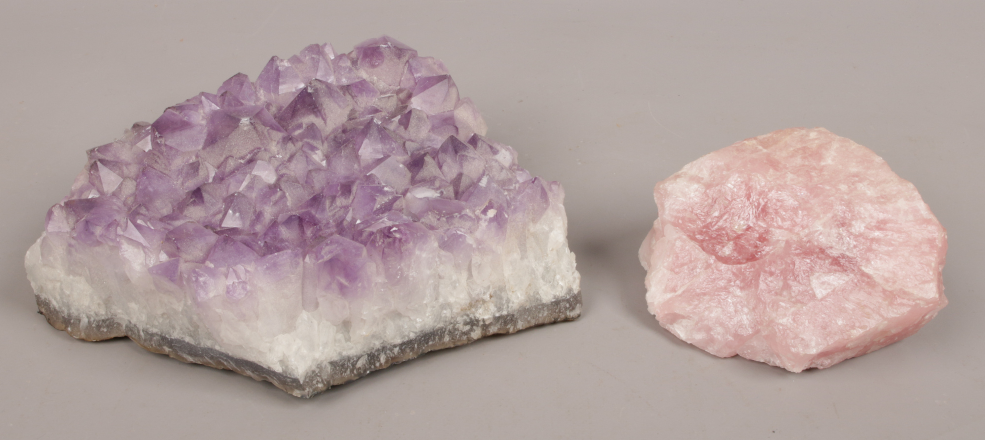 Two geological specimens rose quartz and amethyst.