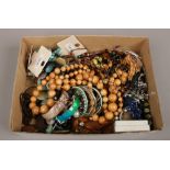 A box of modern costume jewellery to include beads, bangles etc.