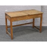 A 20th century double school desk with hinged lid.