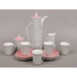 A Polish Cmielow part coffee set with pink finial lids to include cups, coffee pot, sugar bowl etc.