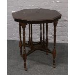 An octagonal mahogany window table raised on cross turned supports.