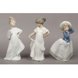 Three Nao ceramic figures of girls.