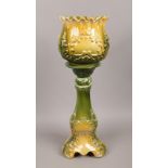 An Edwardian pottery jardiniere on stand with yellow and green glazes.Condition report intended as a