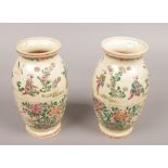 A pair of early 20th century Satsuma vases, decorated with figures in the landscape and cherry