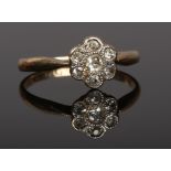 A mid 20th century 18ct gold diamond daisy cluster ring. Size J.