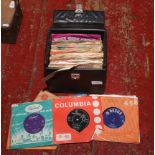 A carry case of 1960s 45rpm single records.