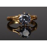 A high carat gold ring with split shoulders set with a colour changing gemstone. Size L.