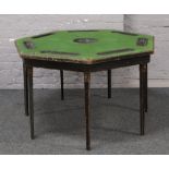 A vintage folding Vono poker table with green beize top.