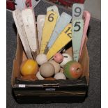 A box of croquet markers and balls.