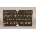 A vintage cast iron L.N.E.R 'Beware of the Trains' plaque 31.5cm x 55.5cm.