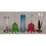 A group of glassware to include decorative bells, vases and a candle holder.