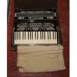 A cased Renaldi Milano Italia piano accordion.
