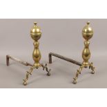 A pair of brass and iron fire dogs.