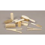 A collection of early 20th century bone and ivory brushes and glove stretchers etc.