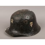 A World War II German helmet with later painted badges.