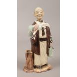 A ceramic nodding figure of a monk.