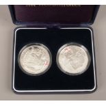 A cased pair of silver proof History of the Royal Navy five pound coins, to include HMS Victory