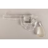 A pressed glass model of a revolver hand gun.