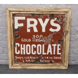 A vintage enamel Fry's Chocolate advertising sign (white text on brown back ground) in later frame.