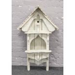 A large limed oak effect bird house, height 102cm.