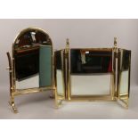 A good quality brass triple fold dressing table mirror with column support and seated lions along