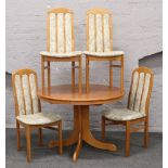 A teak centre pedestal extending dining table, along with a set of four hardwood chairs with