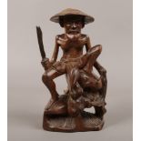 An oriental carved hardwood figure of a fisher man c 1900-20.