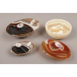 Five carved banded agate bowls of various colour.