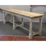 A large farmhouse plank top pine side table with painted base, raised on turned supports and with