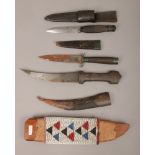 A sheathed hunting knife with worked back blade and leather mounted sheath, an Islamic dagger with