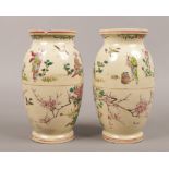 A pair of early 20th century Satsuma vases, decorated with figures in the landscape and cherry