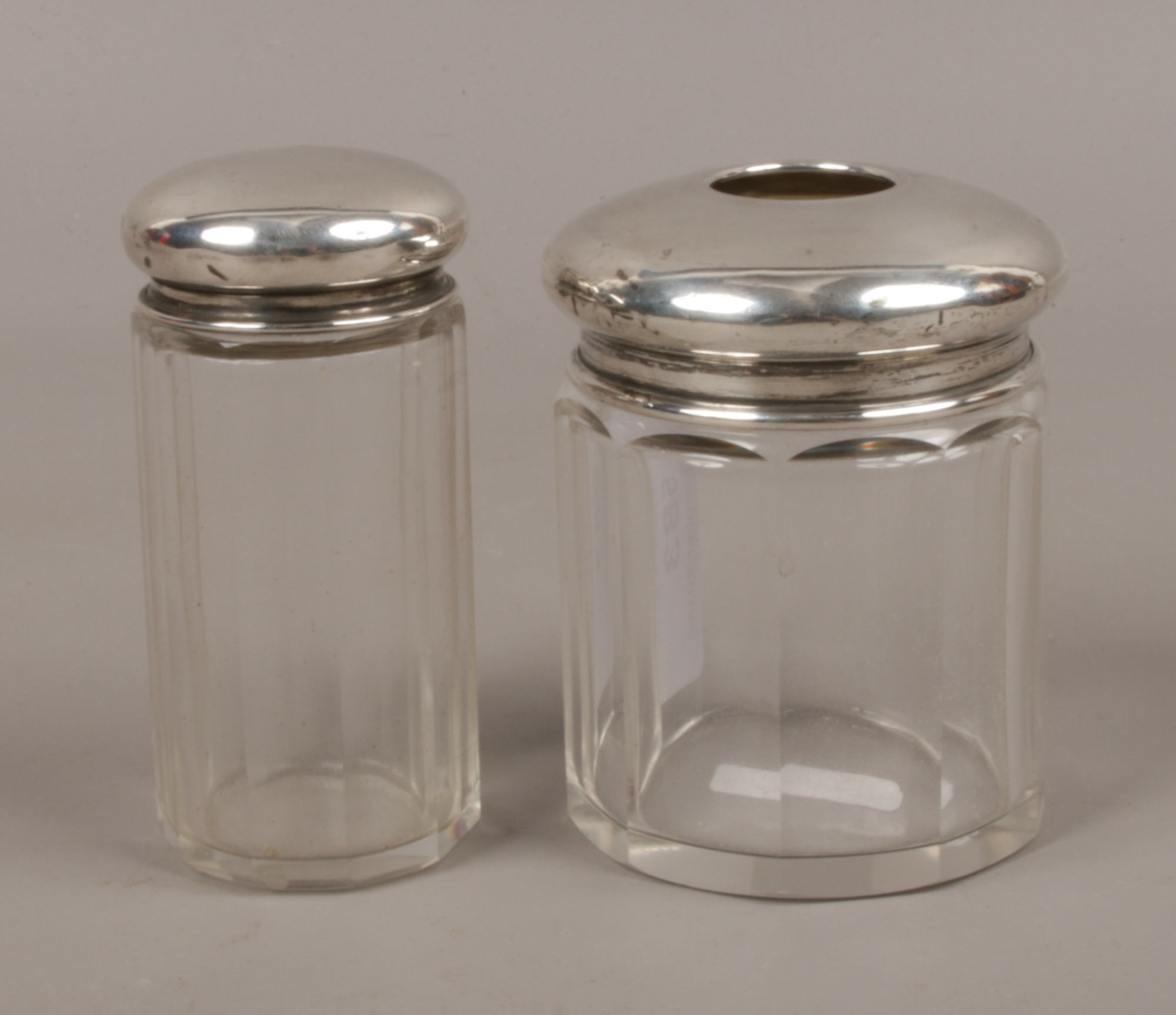 Two silver top glass jars, largest jar assayed Birmingham 1926 S & Co.