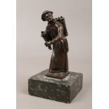 A 19th century patinated bronze figure of a street hawker raised on a marble plinth.