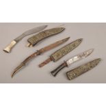 Three 19th century Eastern daggers with filigree and jewelled decoration.