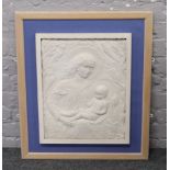 A framed religious relief work plaque, Madonna and The Christ Child, monogrammed J.V.