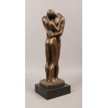 A bronze effect statue of a pair of embracing lovers, raised on a square plinth, signed Klein.