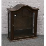 A carved oak dome top hanging display cabinet of small proportions, H 67cm x W 59cm x D 22cm.