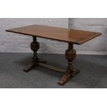 A carved oak refectory dining table raised on bulbous turned legs.